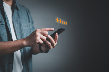 Male customer using smartphone making review satisfaction survey on excellent five star rating in service impressed, feedback for service providers to improve business