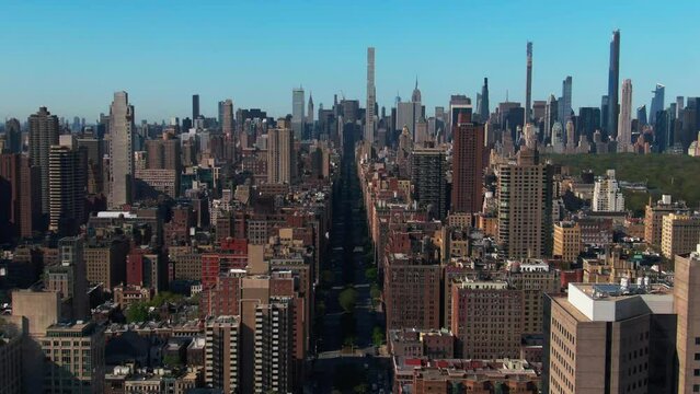 Aerial flight down empty street Park Avenue NYC iconic Manhattan buildings upper east side Central Park cityscape