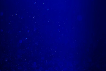 Blue glitter vintage lights background.  blue bokeh shiny on dark background.