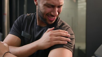 African American multiethnic sad upset tired sporty man feel shoulder ache pain painful hand injury during exercise in sport club gym sportsman athlete male bodybuilder hurt arm problem after workout