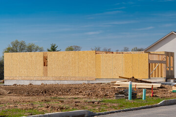 Fototapeta premium construction of a new plywood house against the blue sky