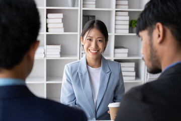 Young beautiful buisnesswoman sitting in the meeting room with her coworker.