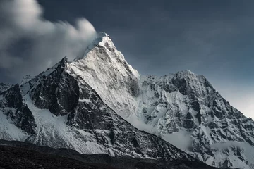 Wall murals Ama Dablam Snow capped Mount Ama Dablam and blurred fast moving clouds behind it in daylight, Nepal, Himalayas