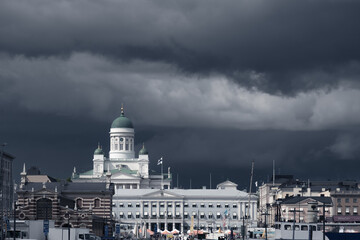 Cityscape with the famous Helsinki Cathedral city's main landmark against dark stormy sky, Finland