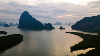 Beautiful rocks in the ocean. Sunny dawn. Clouds in the sky. Beautiful morning water.