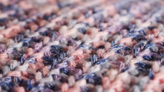 Closeup of blue and pink knitted wool texture of a sweater