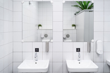 White colour ceramic tiles toilet hand wash area. White colour theme toilet interior. Cleanliness...