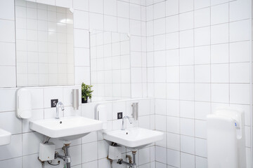 White colour ceramic tiles toilet hand wash area. White colour theme toilet interior. Cleanliness concept. Clean toilet concept.