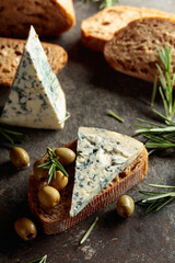 Blue cheese with green olives, rosemary, and bread.
