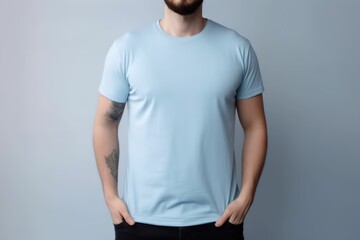 White man model wearing a plain light blue short sleeved t-shirt, isolated on a blank background. Mock-up, torso only. Generative AI illustration.