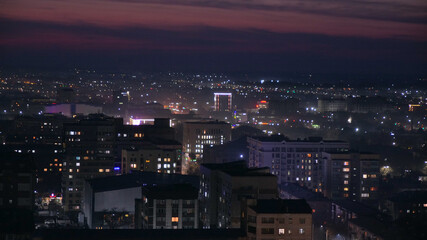 Fototapeta na wymiar Beautiful night city of Bishkek with buildings and cars and fireworks