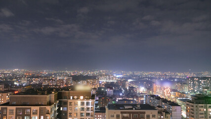 Beautiful night city of Bishkek with buildings and cars and fireworks