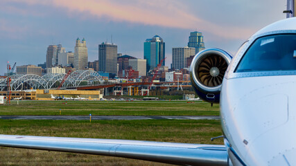 Kansas City at dusk with a private jet in the foreground