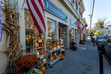 Obraz premium Bright fall day with main street shops and cars in Warwick village, New York, United States