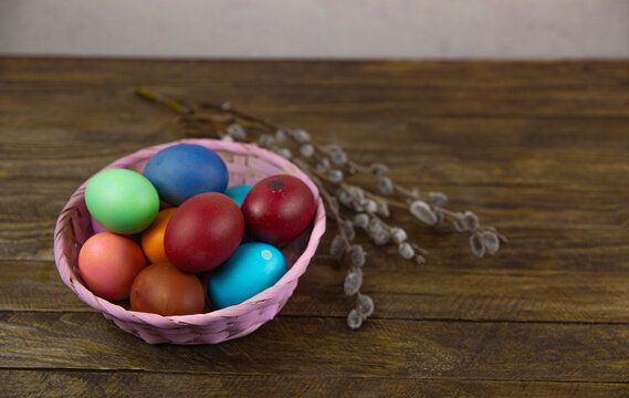 Easter still life with willow branches and a basket of Easter eggs