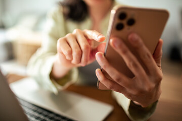 Young Japanese woman using a smart phone in the living room