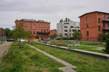 Beautiful garden in Berlin with residential buildings in the background under gray sky