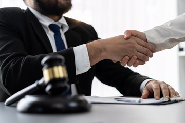 Closeup lawyer or attorneys colleagues handshake after successful legal discussing on contract agreement for lawsuit to advocate resolves dispute in court ensuring trustworthy partner. Equilibrium