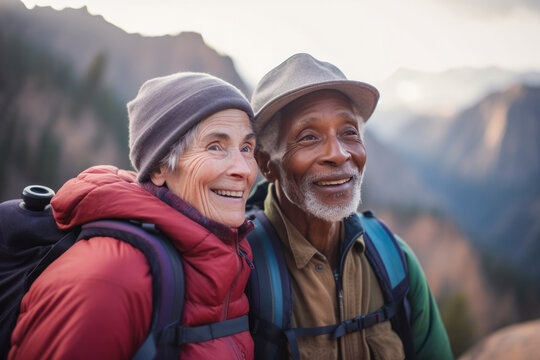 Diverse Senior Hiker Couple Smiling Together With Their Backpacks, Taking Photos Against A Beautiful Mountain Background, Celebrating An Active And Healthy Retirement. Generative AI