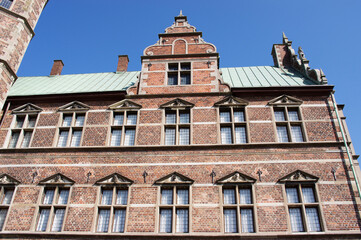 Facade and roof of Rosenborg castle in Copenhagen in Denmark with a clear blue sky