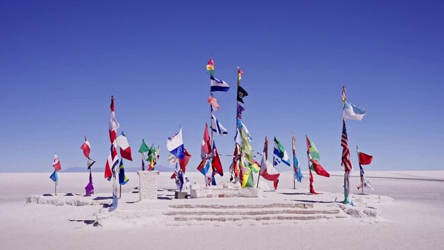 Uyuni flags from many nations waving with the wind at slow motion