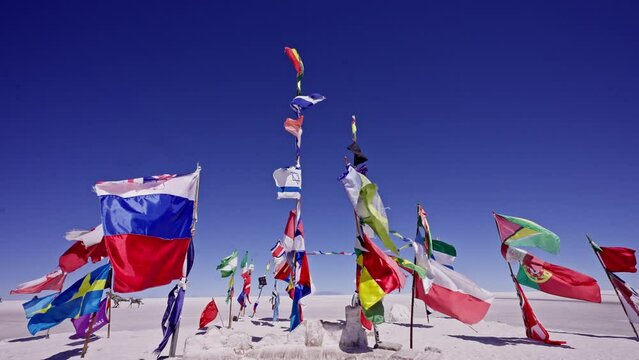 Uyuni flags from many nations waving with the wind at slow motion