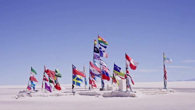 Uyuni flags from many nations waving with the wind at slow motion
