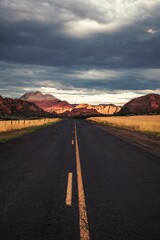 Fototapeta na wymiar Vertical shot of a road leading to the mountains in Utah, USA
