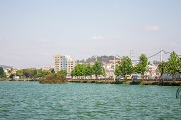 Fototapeta premium Low-angle view of modern buildings near the lake on a sunny day in Madagascar