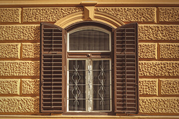 Fototapeta na wymiar View at an old shappy chic window and the facade of an old house