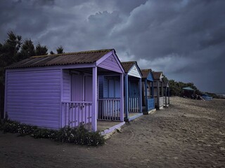 Fototapeta na wymiar Group of small cabins near the beach on a clouded day