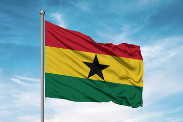Ghana national flag cloth fabric waving on beautiful sky Background.