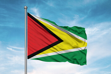 Guyana national flag cloth fabric waving on beautiful sky Background.