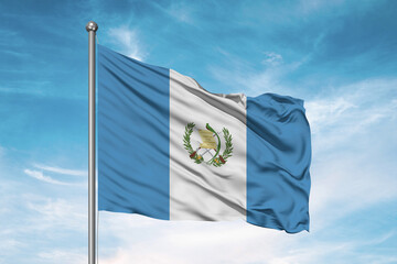 Guatemala national flag cloth fabric waving on beautiful sky Background.