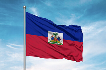 Fototapeta na wymiar Haiti national flag cloth fabric waving on beautiful sky Background.