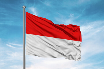 Obraz na płótnie Canvas Indonesia national flag cloth fabric waving on beautiful sky Background.