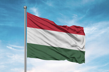 Fototapeta na wymiar Hungary national flag cloth fabric waving on beautiful sky Background.