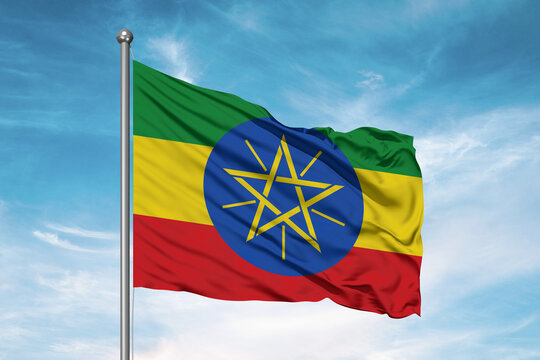 Ethiopia national flag cloth fabric waving on beautiful sky Background.