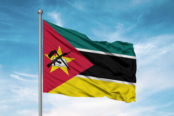 Fototapeta na wymiar Mozambique national flag cloth fabric waving on beautiful sky Background.