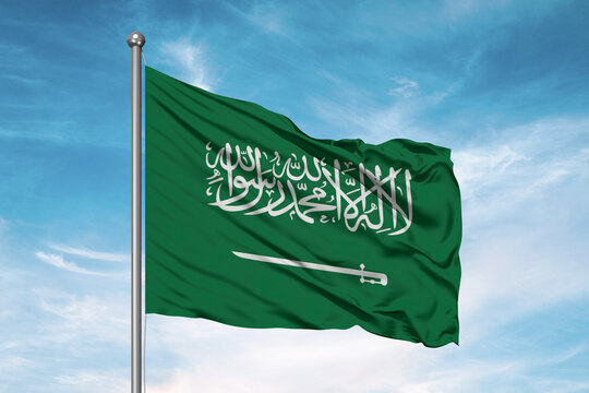 Saudi Arabia national flag cloth fabric waving on beautiful sky Background.