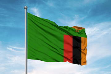 Zambia national flag cloth fabric waving on beautiful sky Background.