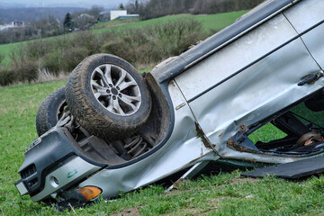 Big SUV car after rollover on the roof in nature. Car crash in agricultural field. Accident on a...