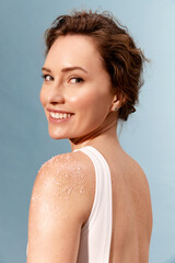 Portrait of real smiling woman  with white scrub on the shoulder