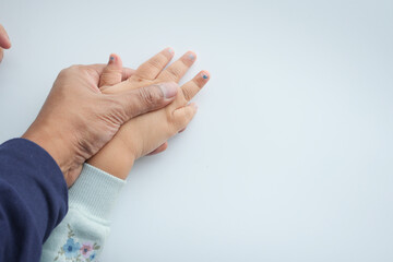 father holding hand of baby child on white background 