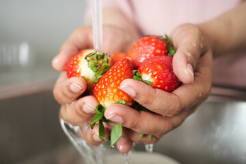 fresh strawberry washing with hand. - Powered by Adobe