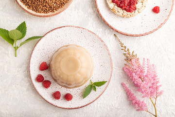 Buckwheat milk jelly on gray concrete, top view.