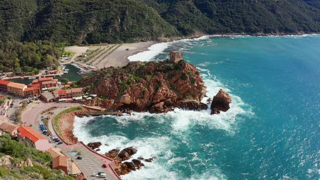 4k drone forward video (Ultra High Definition) of Porto town with Genoise de Porto Ota tower. Aerial spring view of Corsica island, France, Europe.  Traveling concept background..