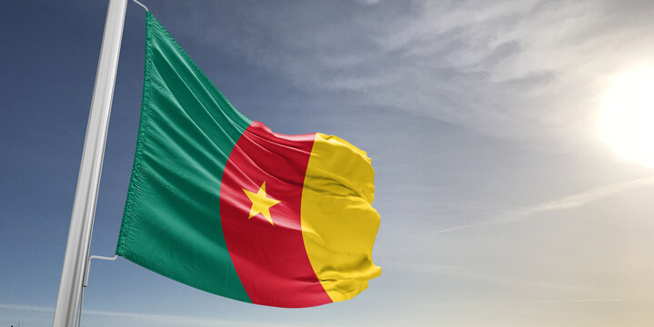 Cameroon national flag cloth fabric waving on beautiful sky grey Background.