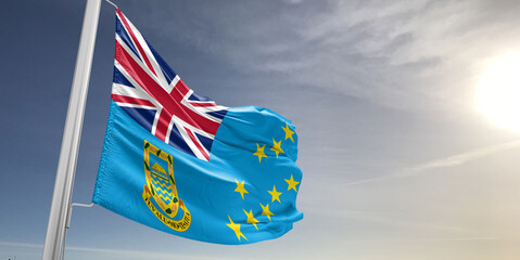 Tuvalu national flag cloth fabric waving on beautiful sky grey Background.