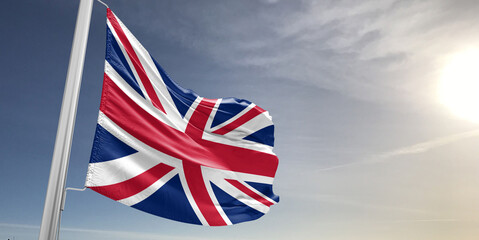 United Kingdom national flag cloth fabric waving on beautiful sky grey Background.